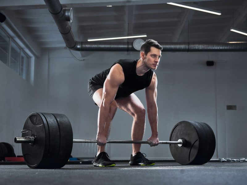 man-doing-barbell-exercise-at-gym-during-weight-YTHEXN2-e1700148435926.jpg